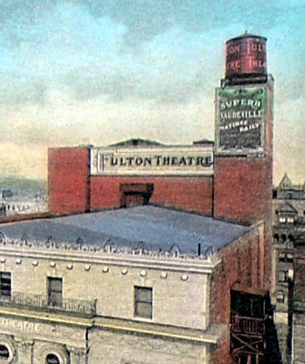 Close-up of back of theater. Montrose Morris' Alhambra Apartments can be glimpsed in the background.