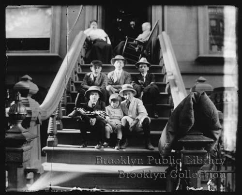 Children sitting on a stoop on Bed Stuys Herkimer Street, circa 1900. Photo by Daniel Berry Austin via the Brooklyn Public Library