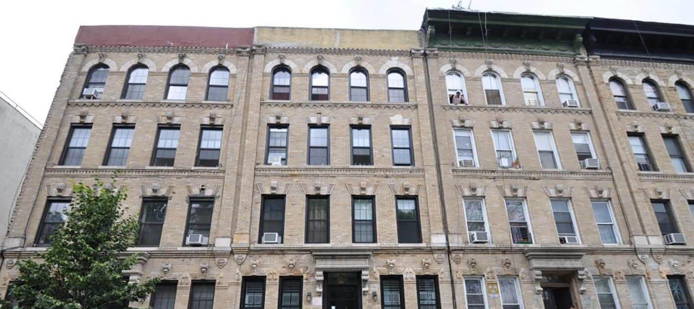 A row of typical multifamily apartment buildings in Bushwick that contain railroad apartments. Photo by Christopher Bride via Property Shark