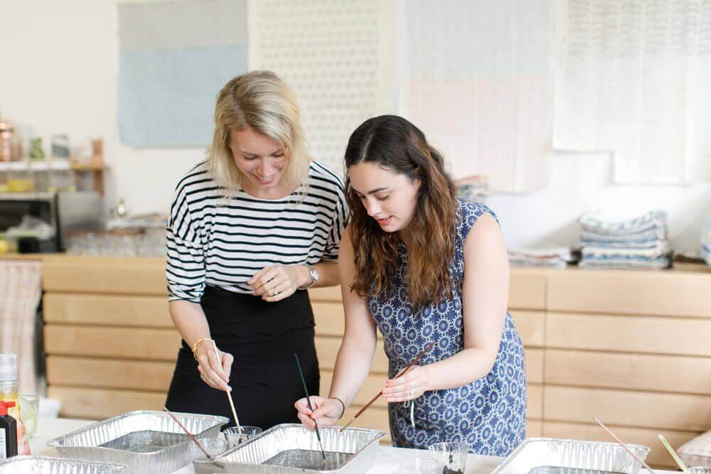 Rebecca Atwood, right, shows an interior designer how to marble paper. Photo by Tory Williams