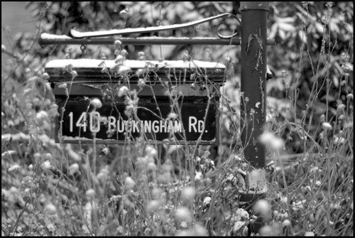 black and white photo of a sign with snow