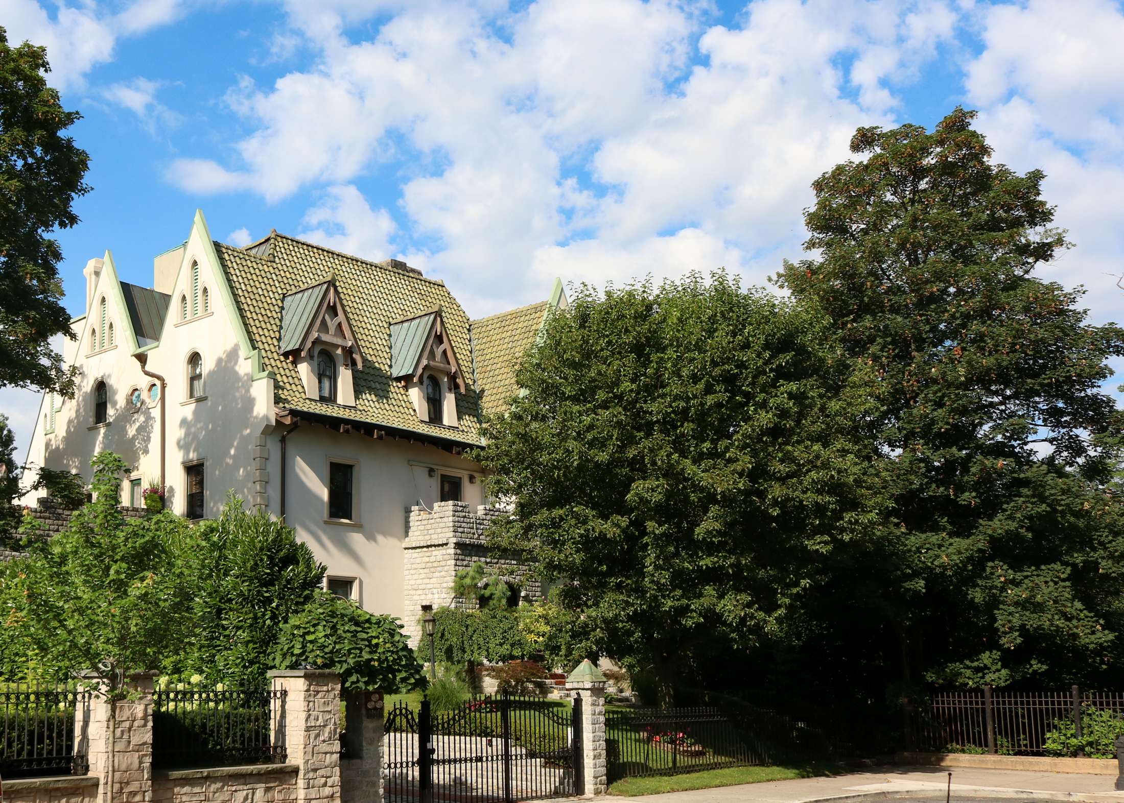 bay ridge - house with a green tile roof and dormers