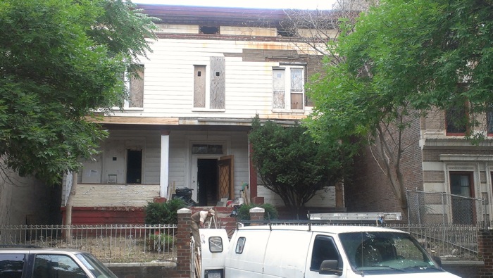 van in front of wood frame house