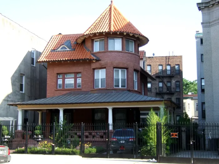 freestanding house with a porch and a turret
