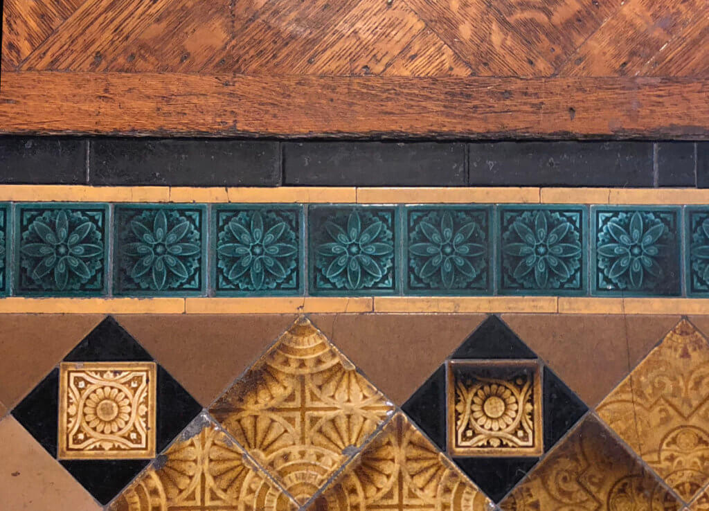 stately bed stuy brownstone with ornate woodwork, tile