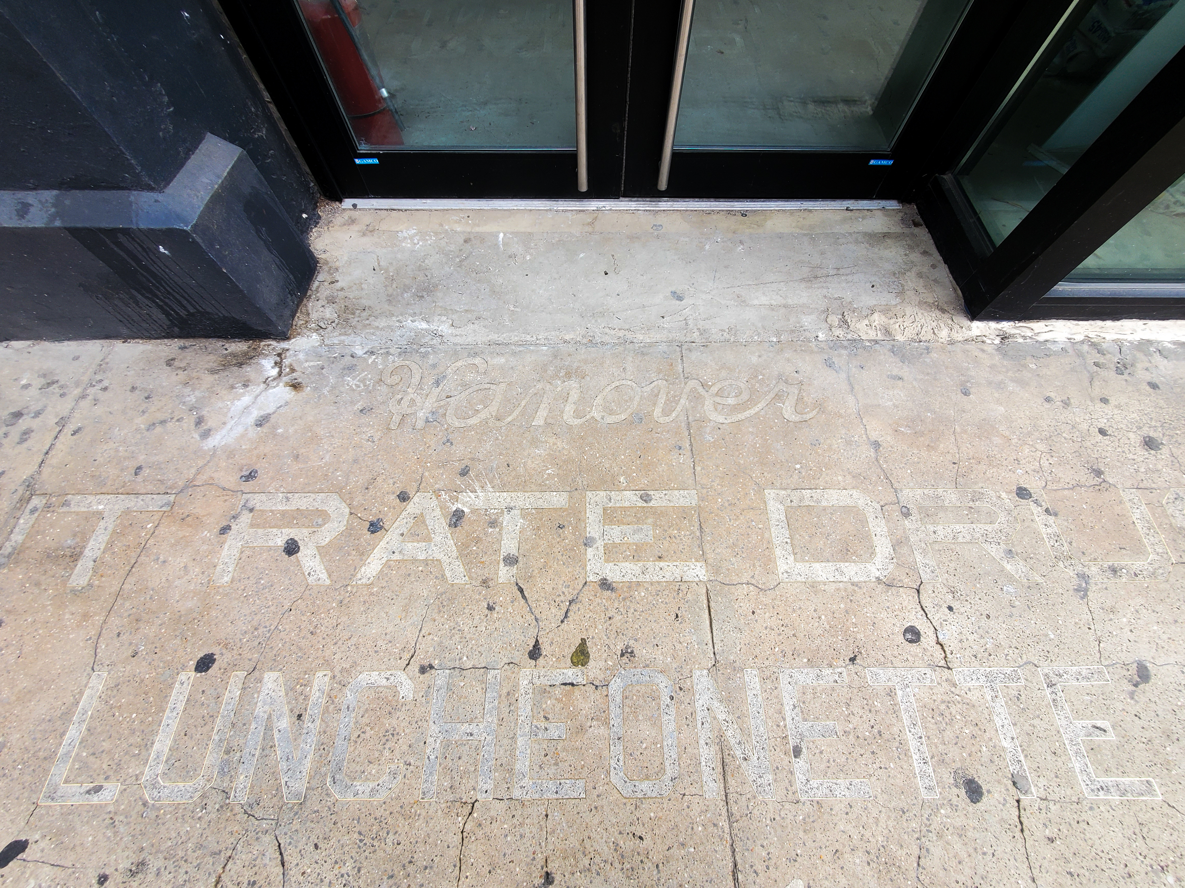 ghost sign on sidewalk