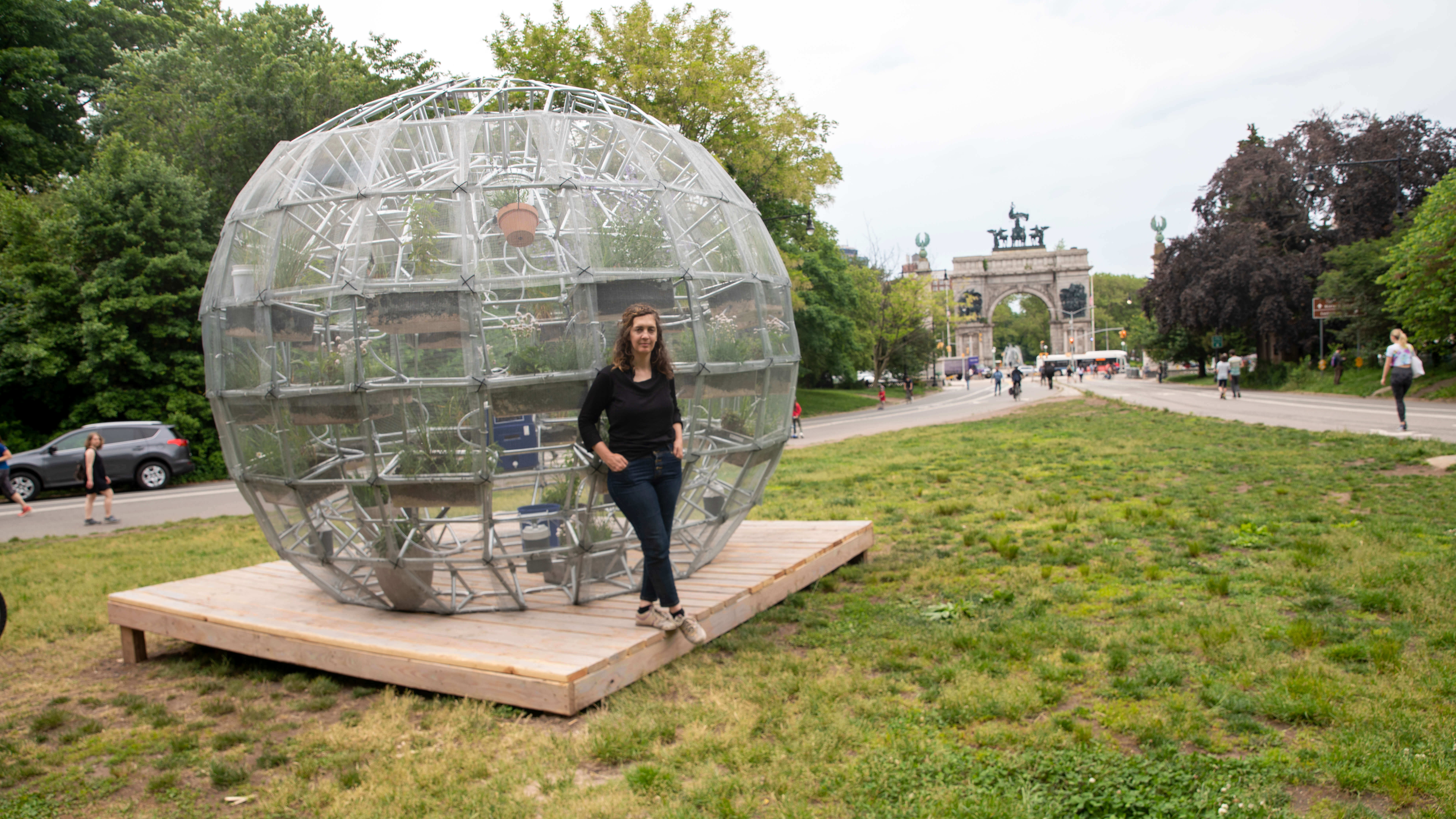 The artist standing in front of her sculpture. 