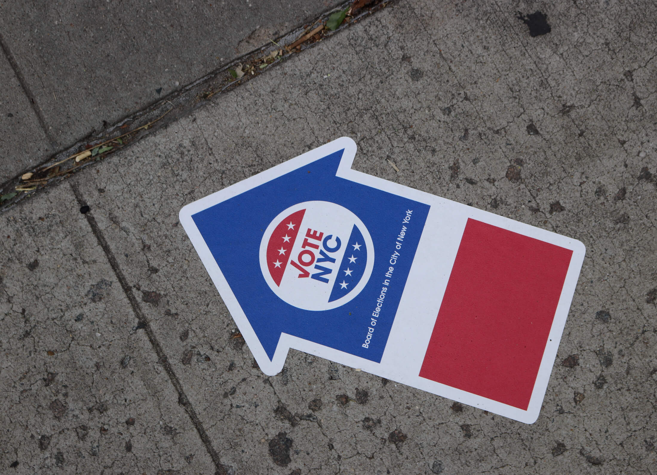 election sticker on sidewalk