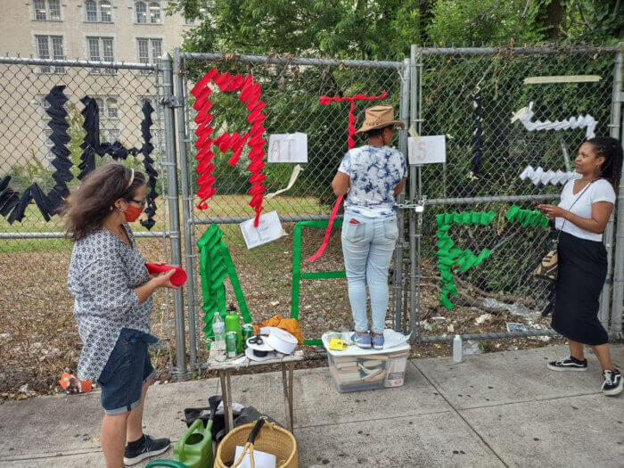 Members of the coalition weaving the fence