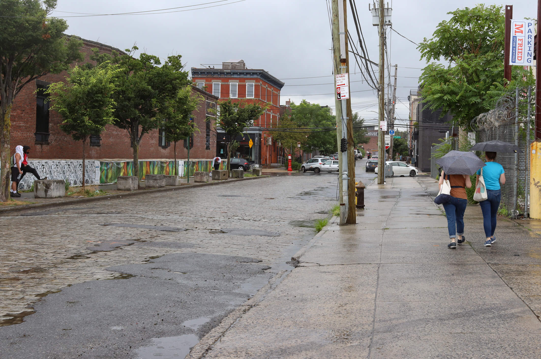 people walking in the rain in Red Hook Brooklyn