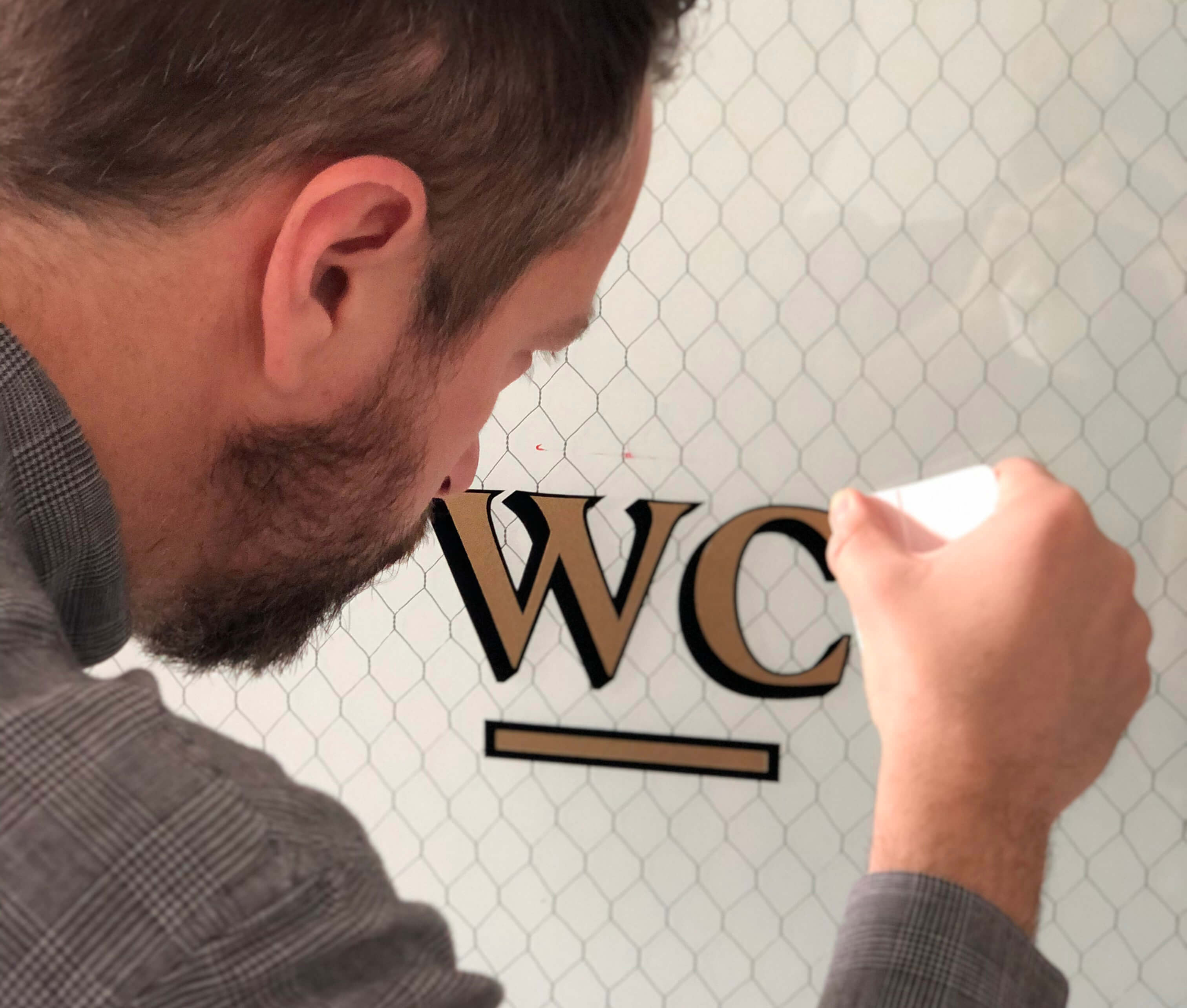 putting vintage style lettering on a glass door