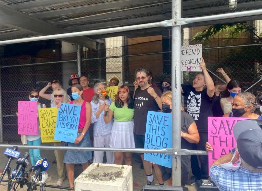 activists rally outside building