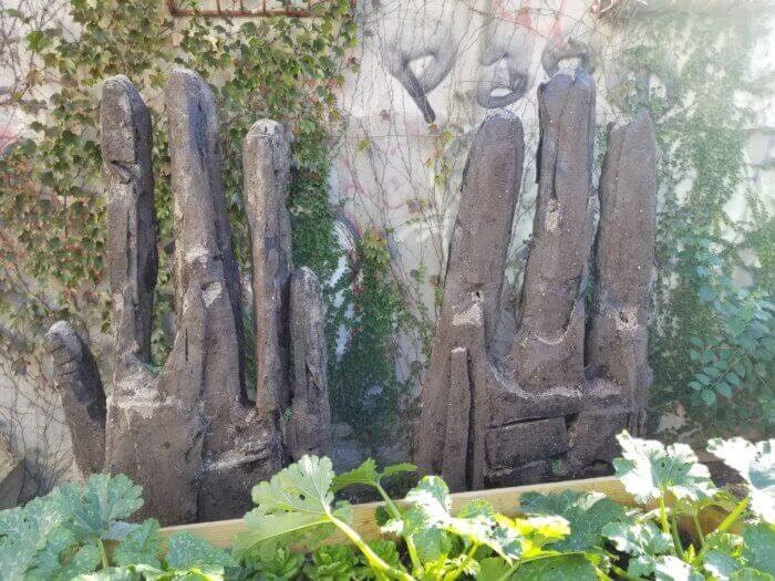 earthen hands in the garden