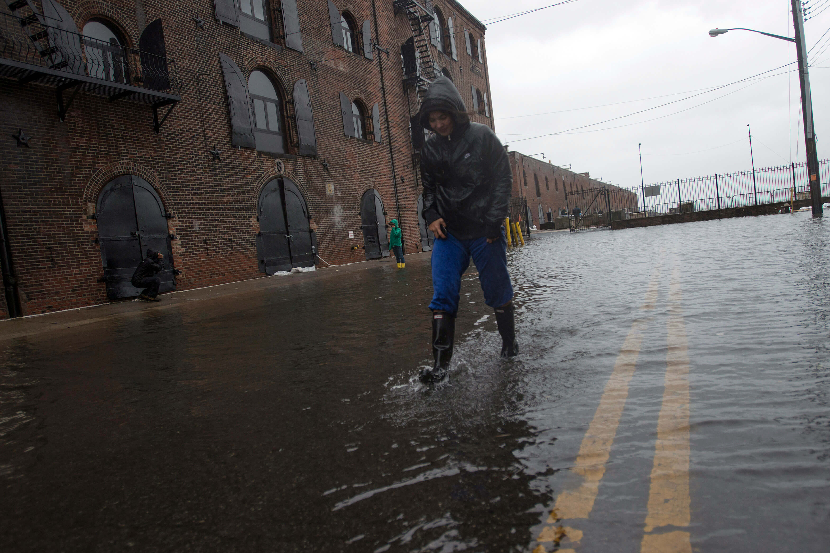 woman walking in red hook during hurricane sandy