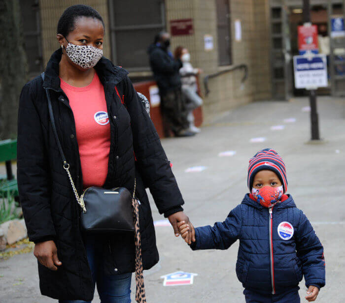 mother and child in voting line