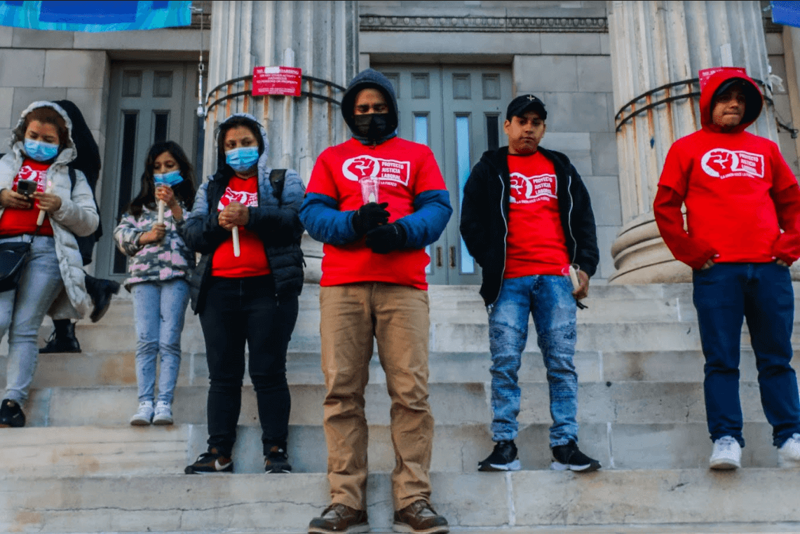 Workers Justice Project members light candles in memory of colleagues who died on the job