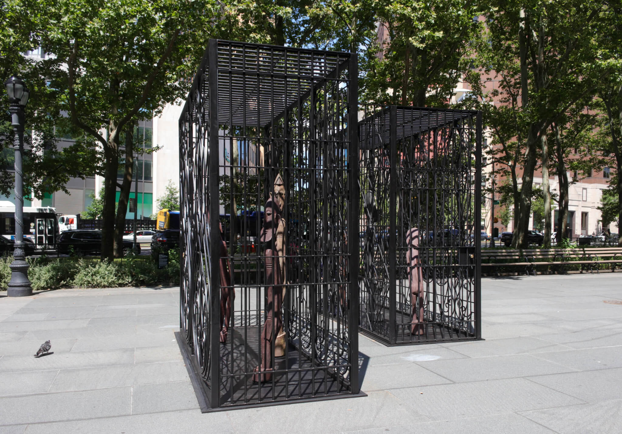 pigeon looking at the black metal sculpture