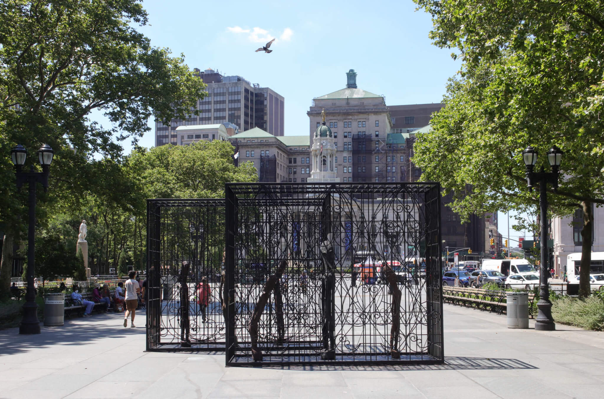 view of black metal sculpture with borough hall behind it