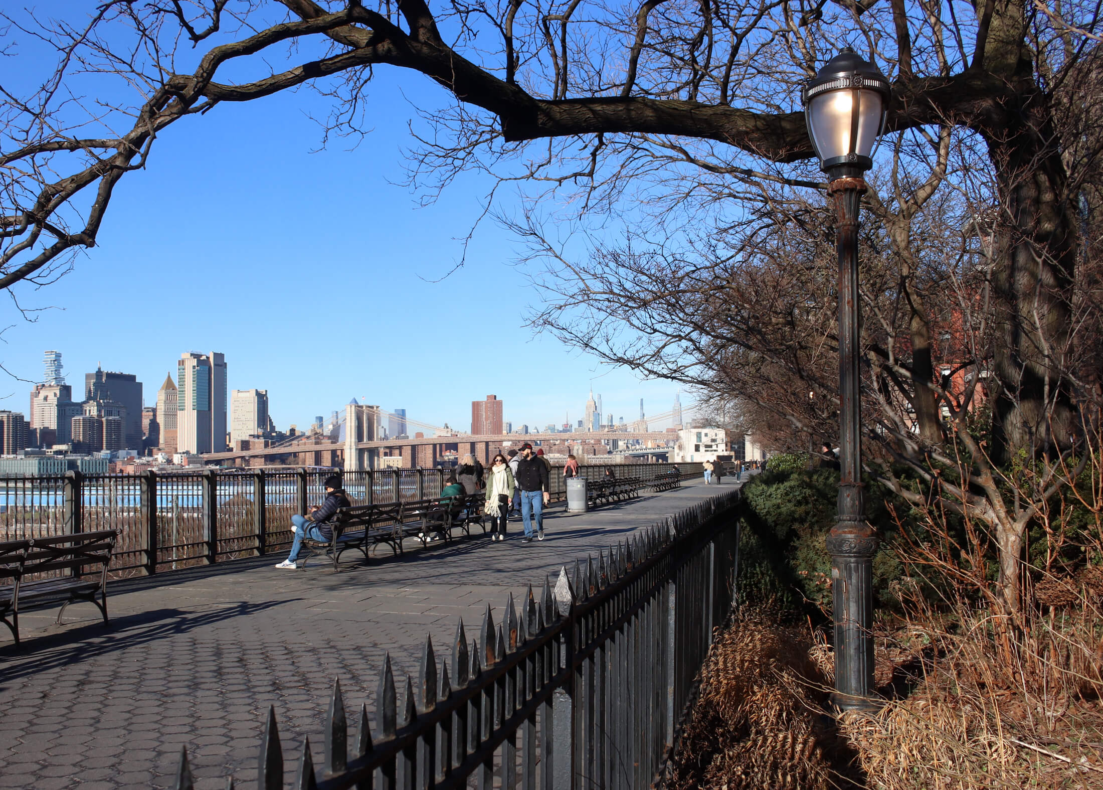 people walking on the brooklyn heights promenade