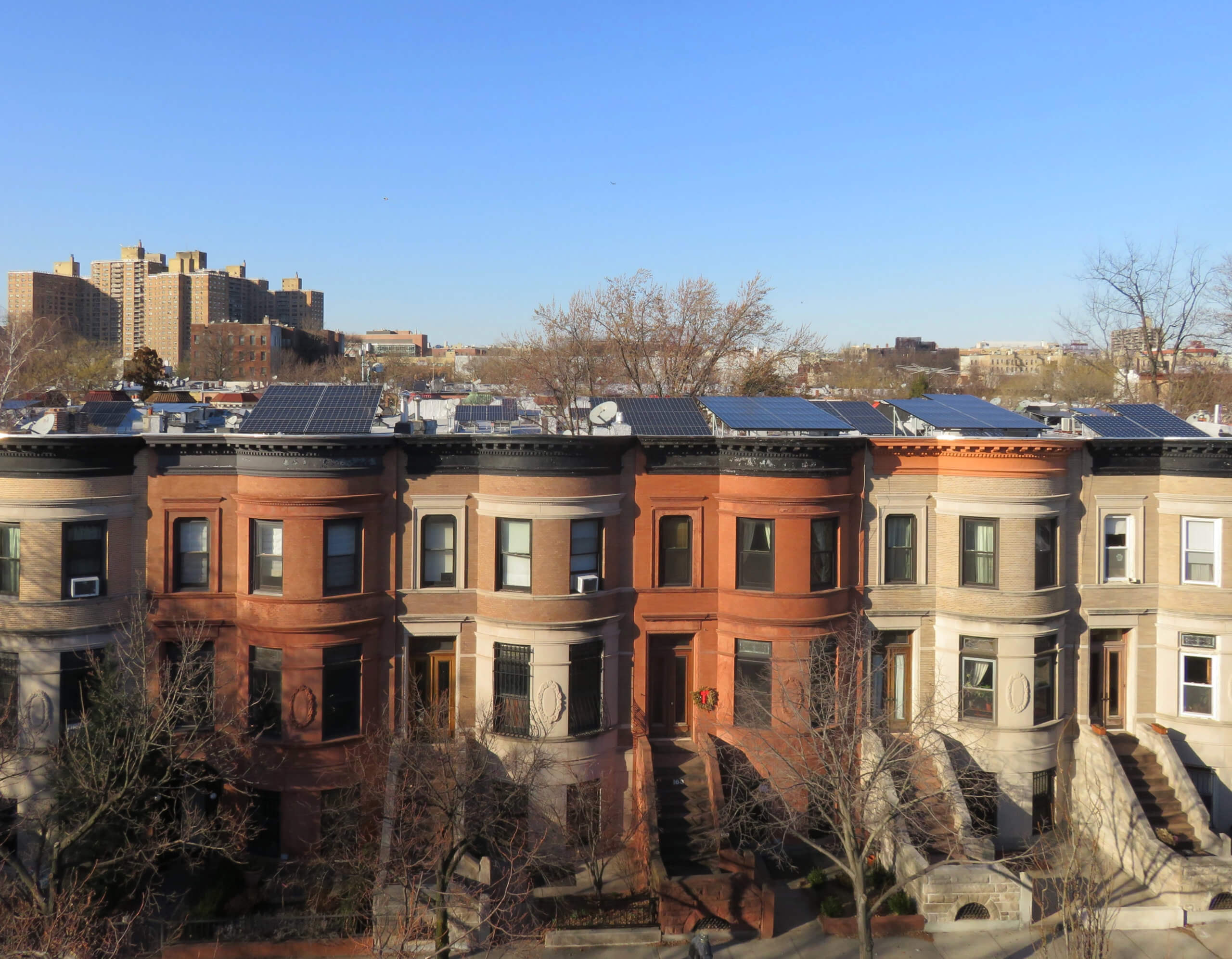 row of brownstones in Brooklyn with solar panels
