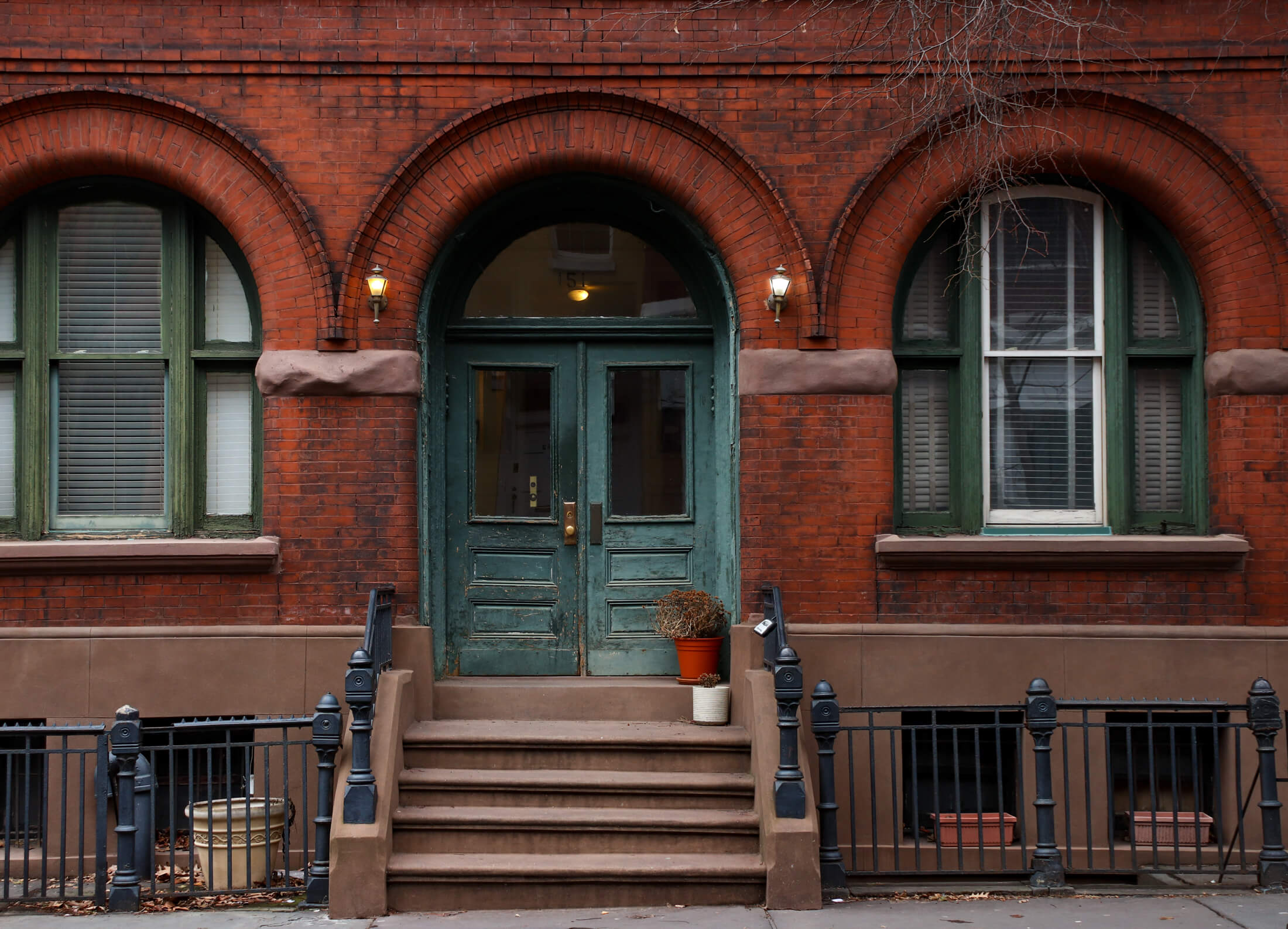 stoop of brick romanesque revival building