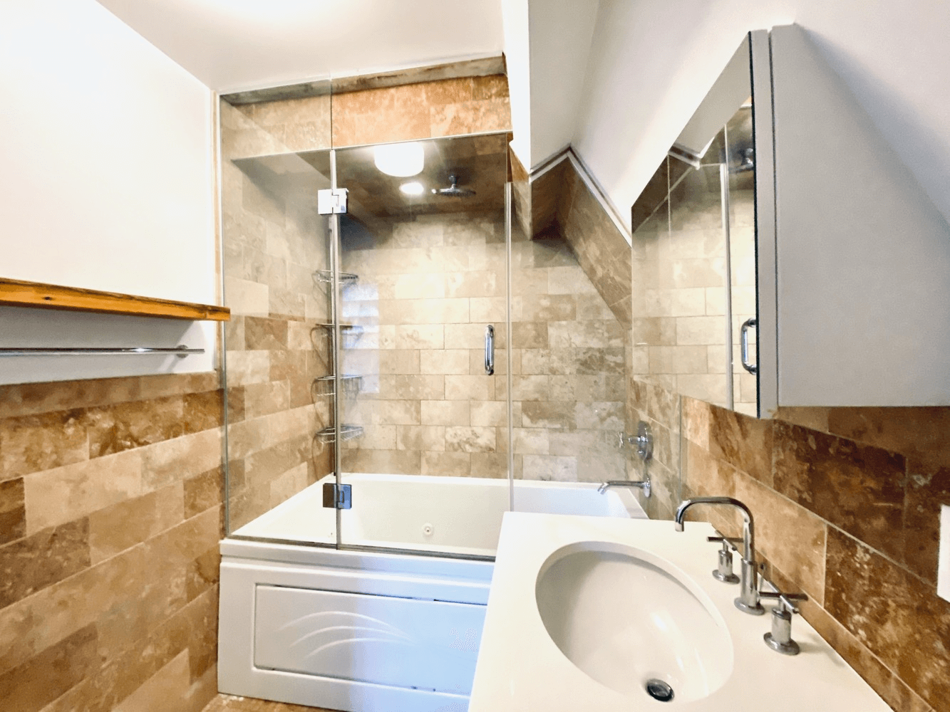 bathroom with white fixtures and brown tile