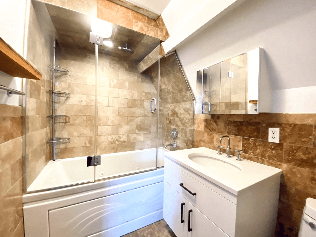 bathroom with white fixtures and brown tile
