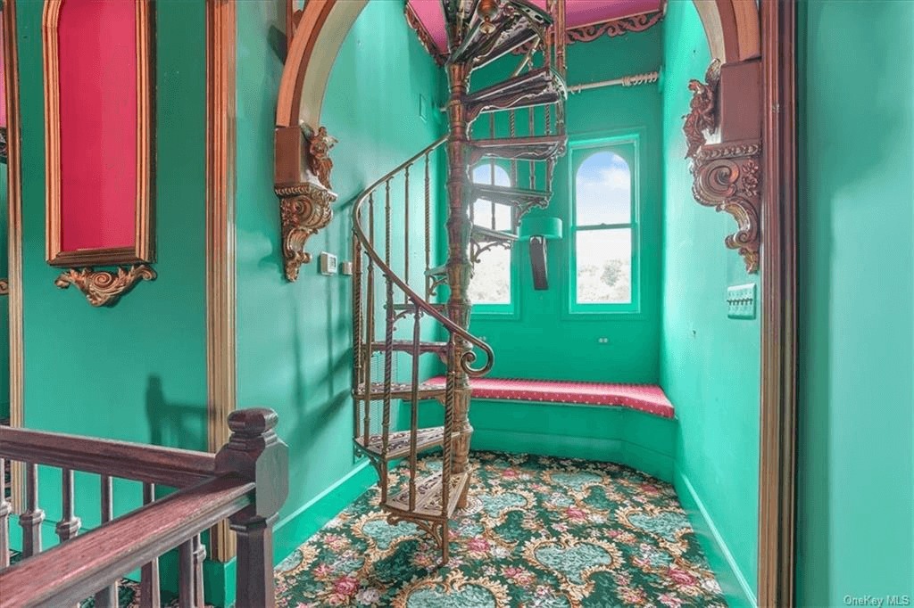 the third floor gallery space with painted walls and carpeted floors inside 313 main street goshen