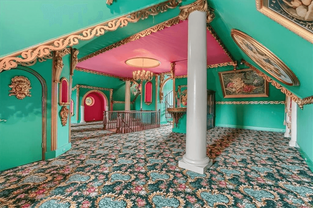 the third floor gallery space with painted walls and carpeted floors inside 313 main street goshen