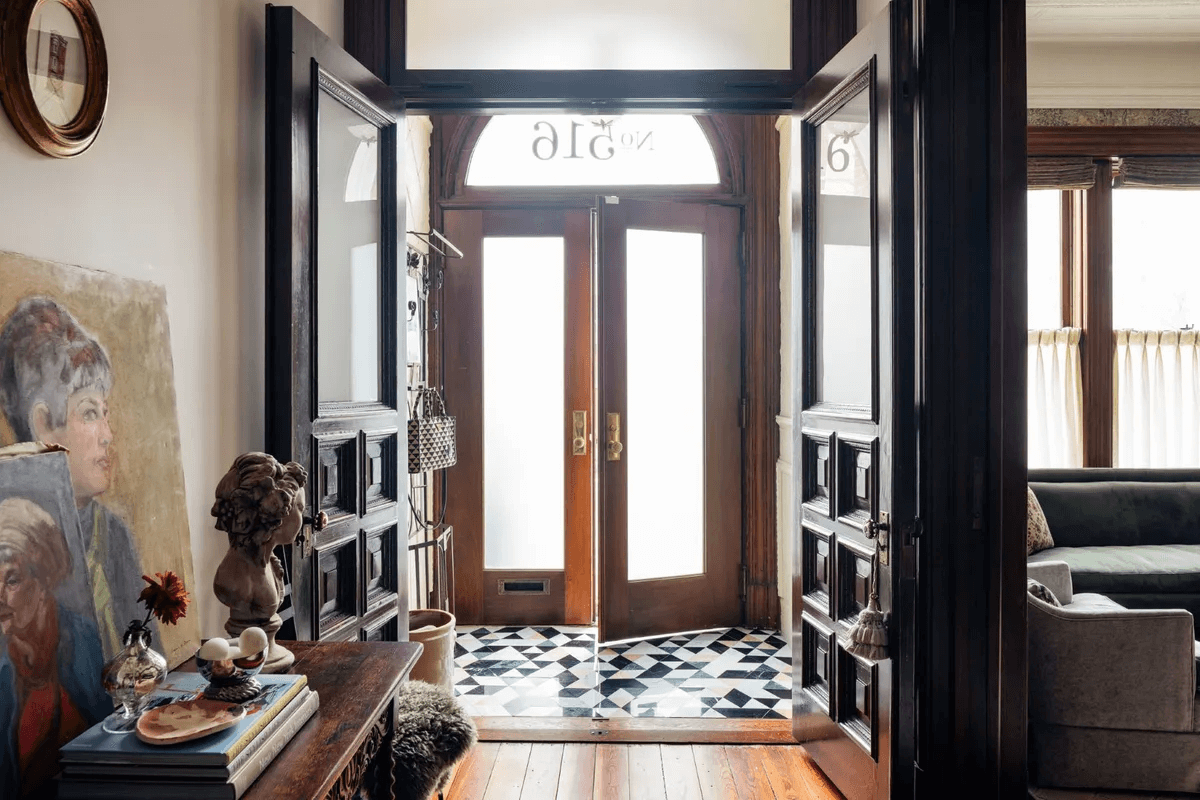 entry with black and white tile in foyer