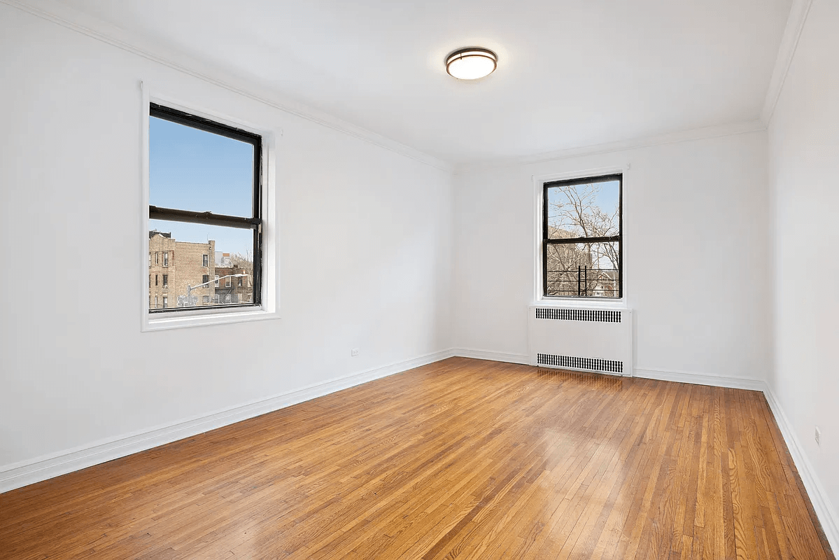 bedroom with wood floor and two exposures