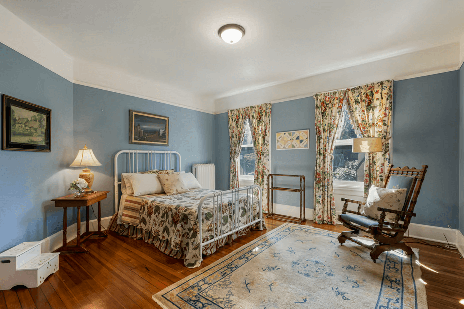 bedroom with wood floor and picture rail