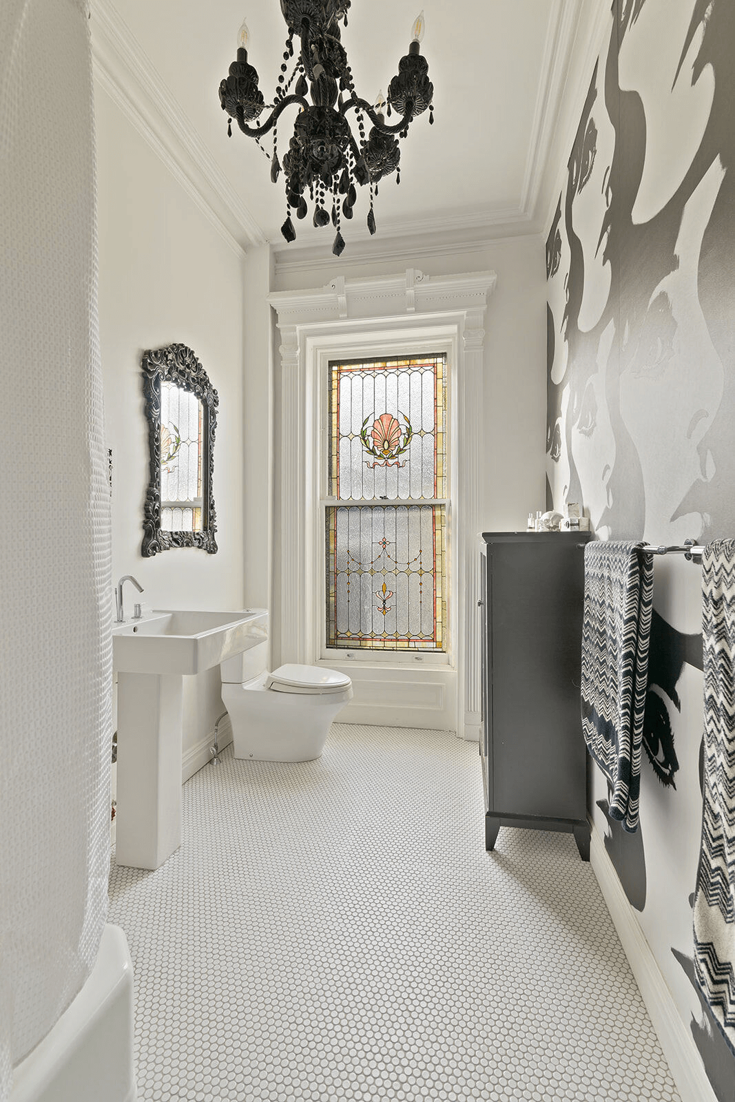 bathroom with stained glass window and black and white wallpaper