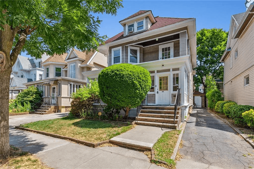 front view of 761 east 22nd street with view of driveway and garage