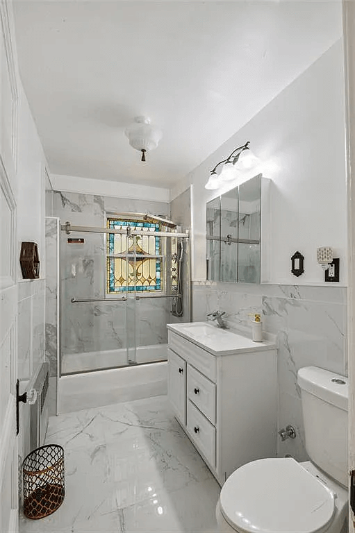 bathroom with stained glass window in 761 east 22nd street