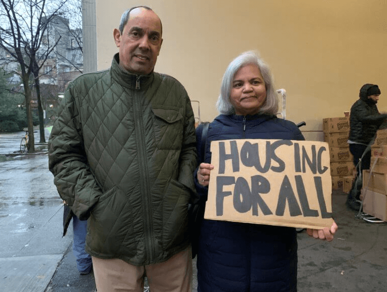 bedford gardens residents with a sign that says housing for all