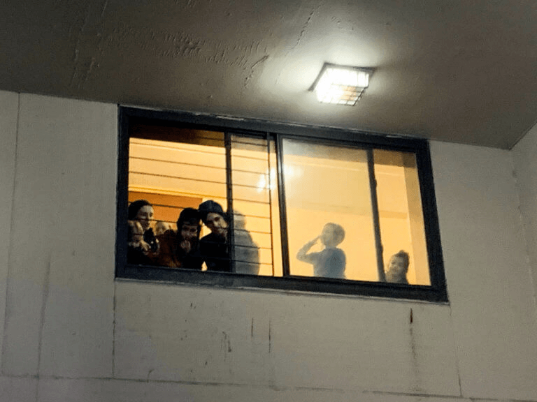 residents looking out a window