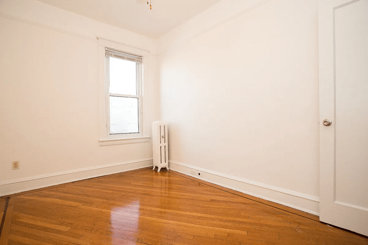 small bedroom with wood floor