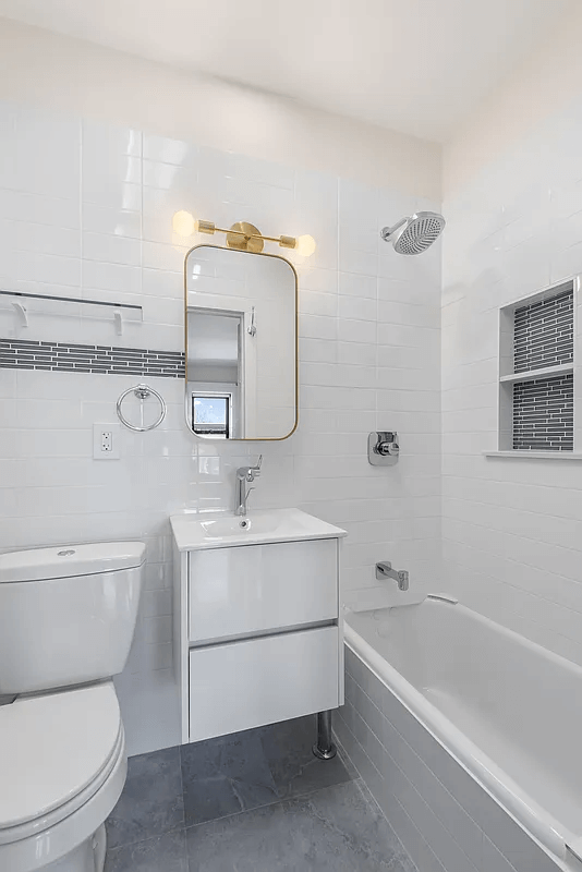 bathroom with white fixtures and subway tiles