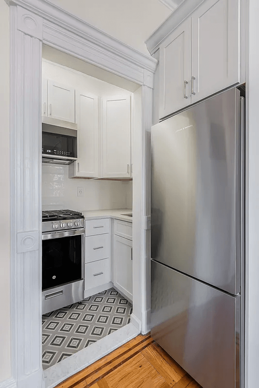 kitchen with tile floor and white cabinets