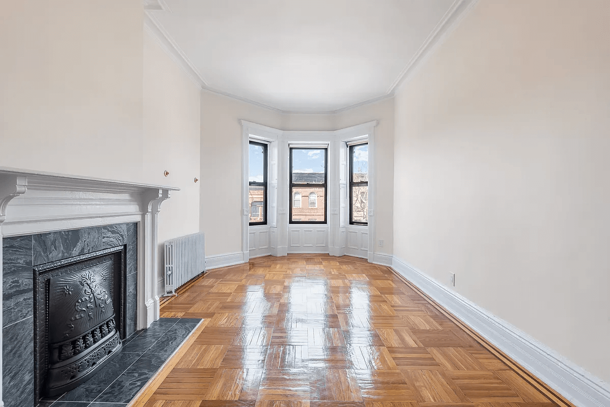 living room with bay window and mantel