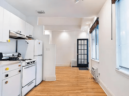 kitchen with white cabinets and view toward entrance