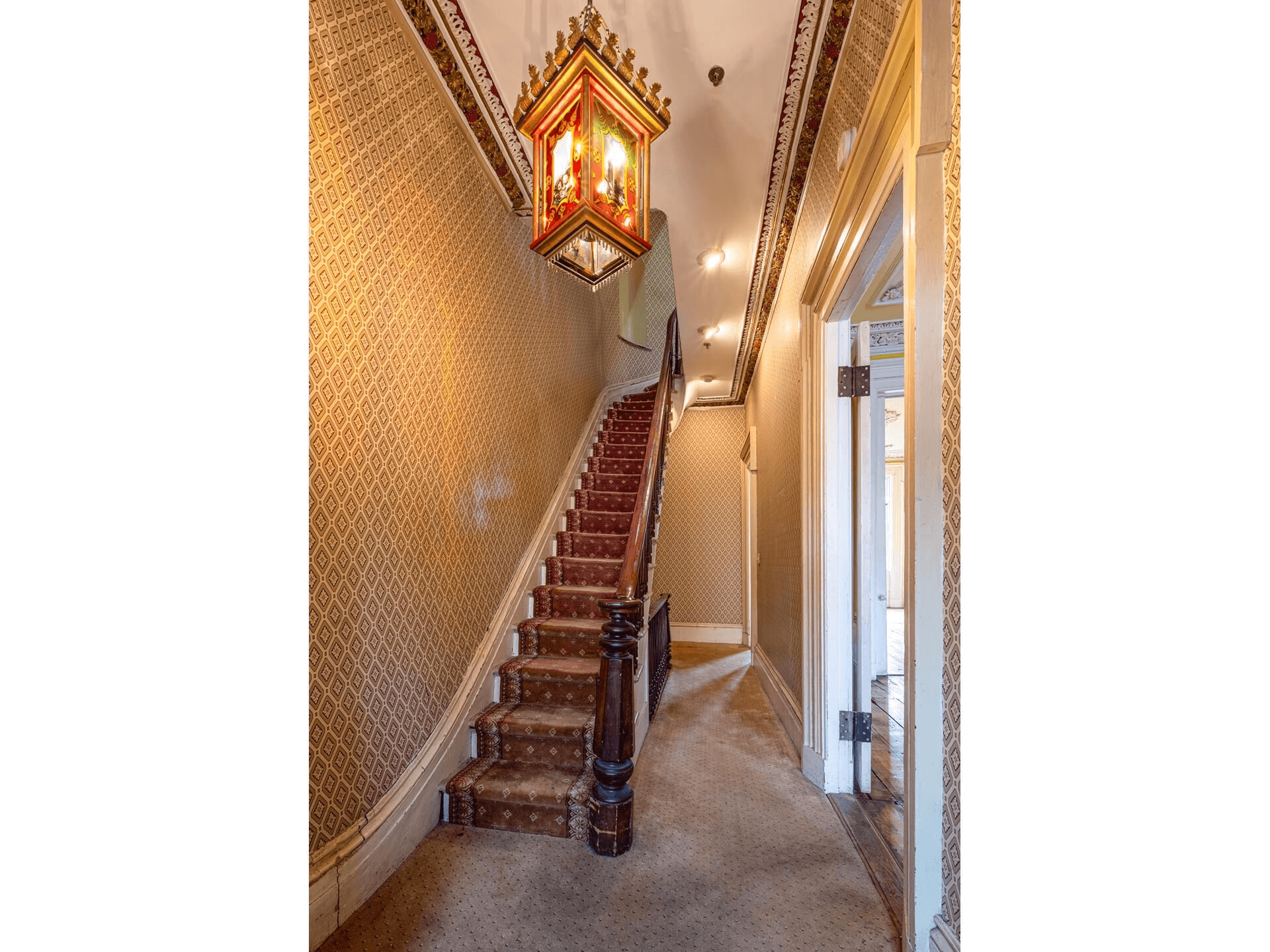 entry hall with wallpaper, carpet and original stair