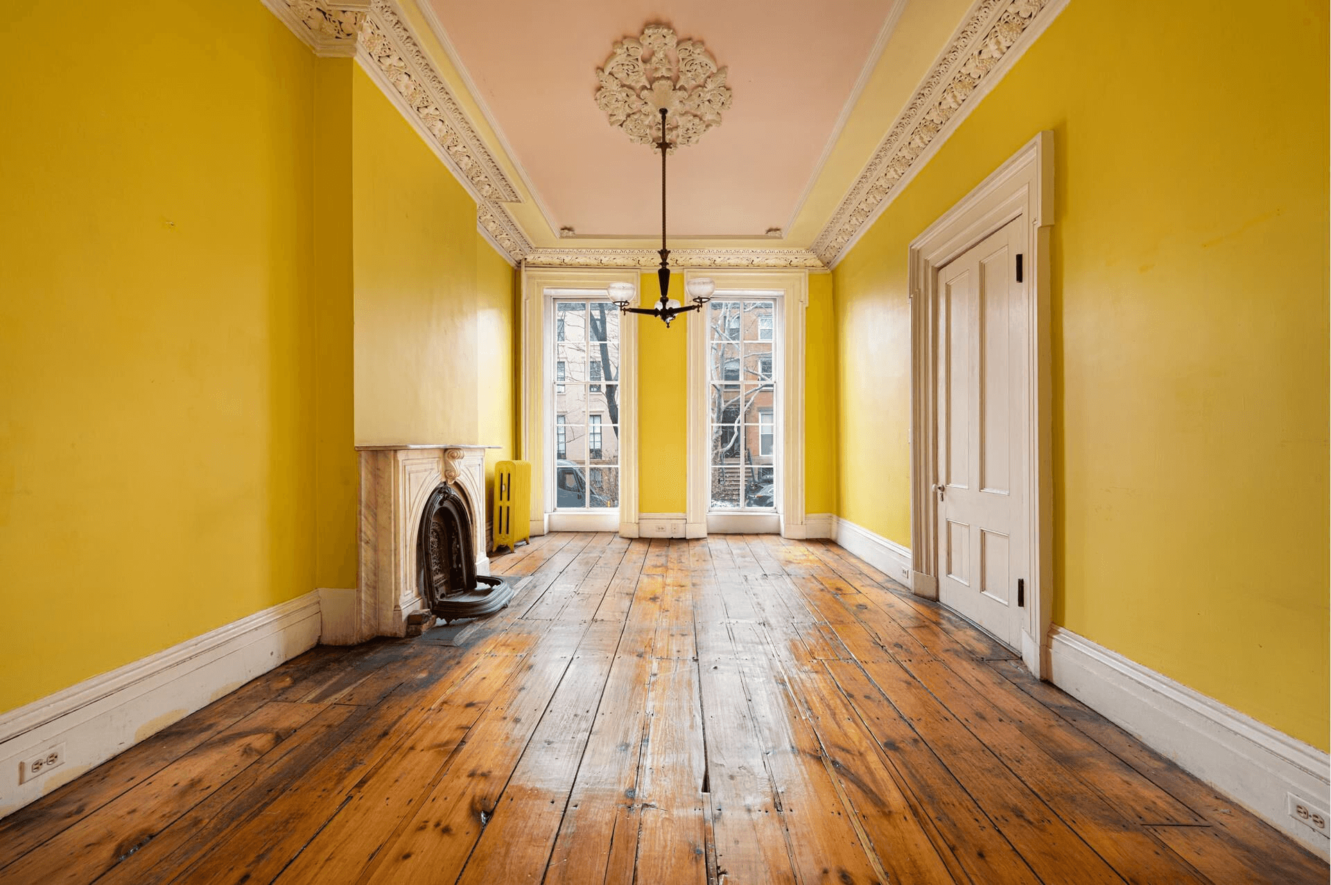parlor with plasterwork and marble mantel