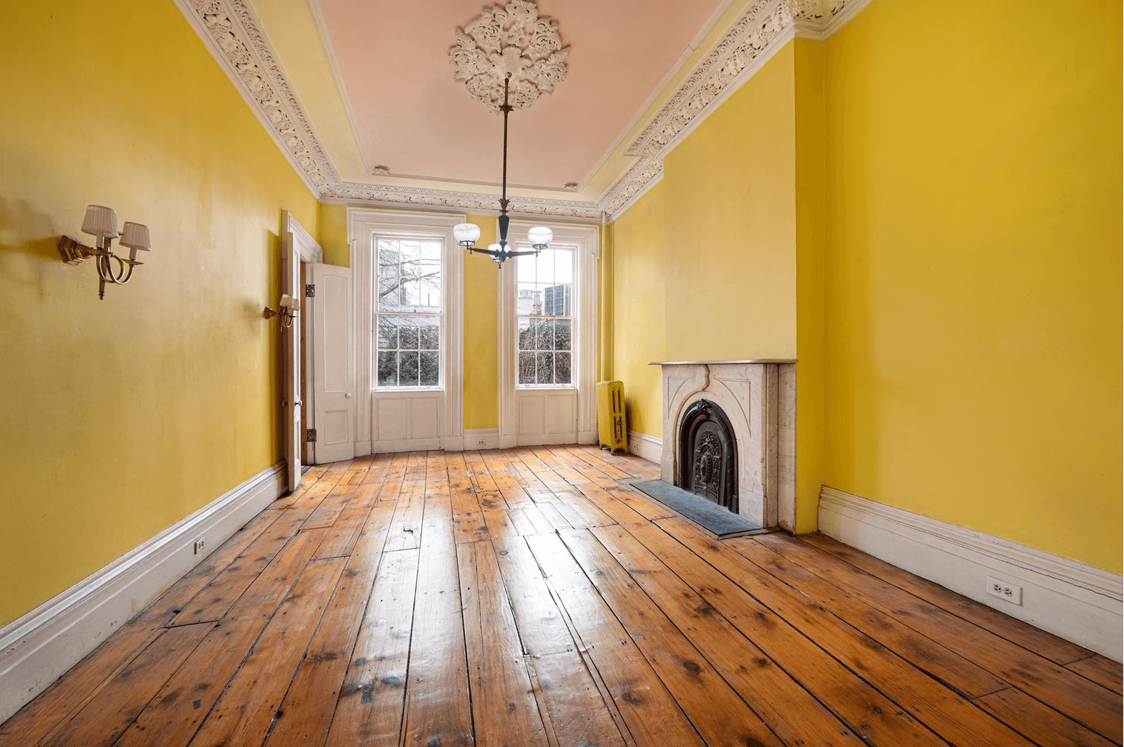 parlor with plasterwork and marble mantel