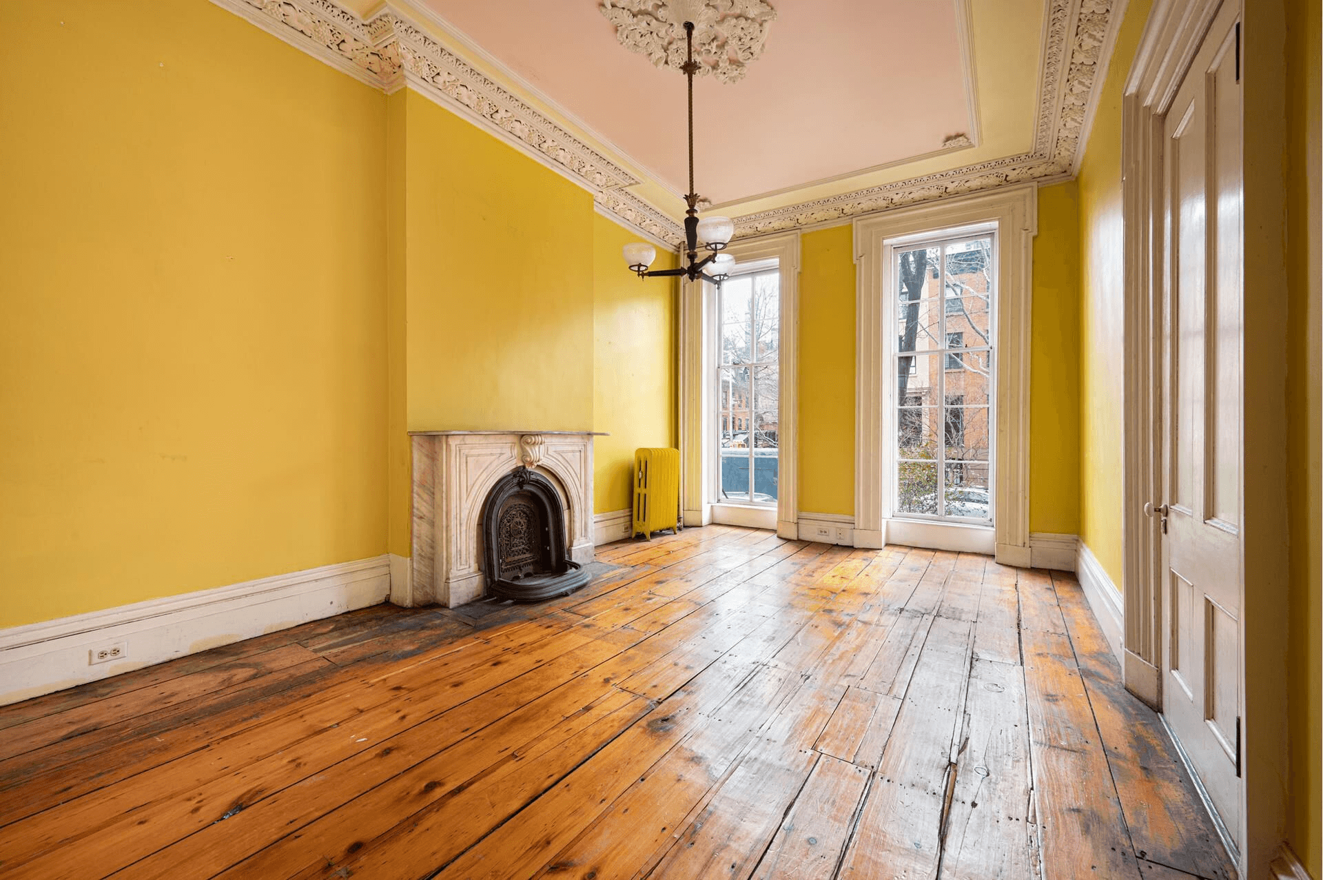 parlor with plasterwork and marble mantel