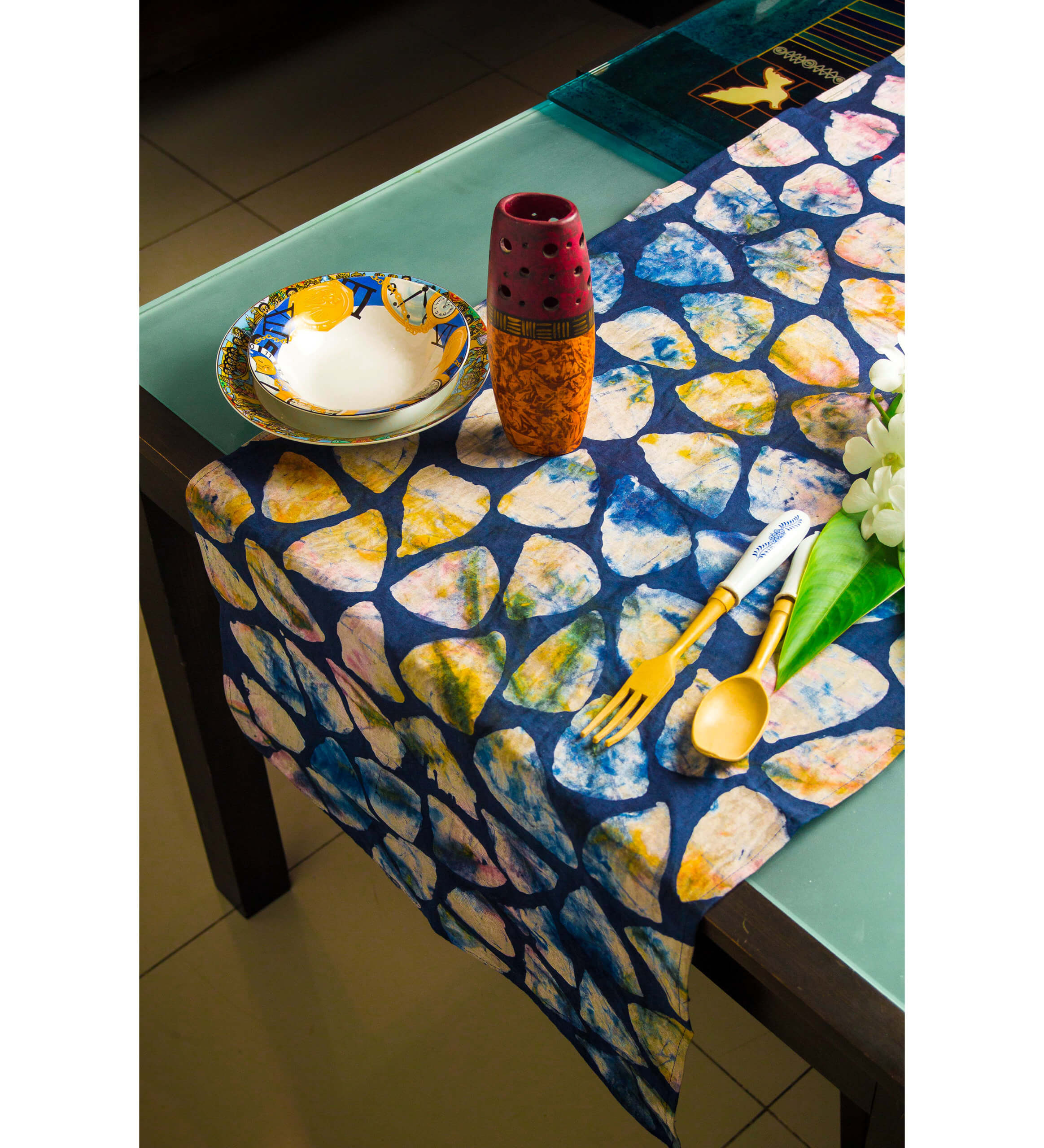 a table set with a vibrant runner