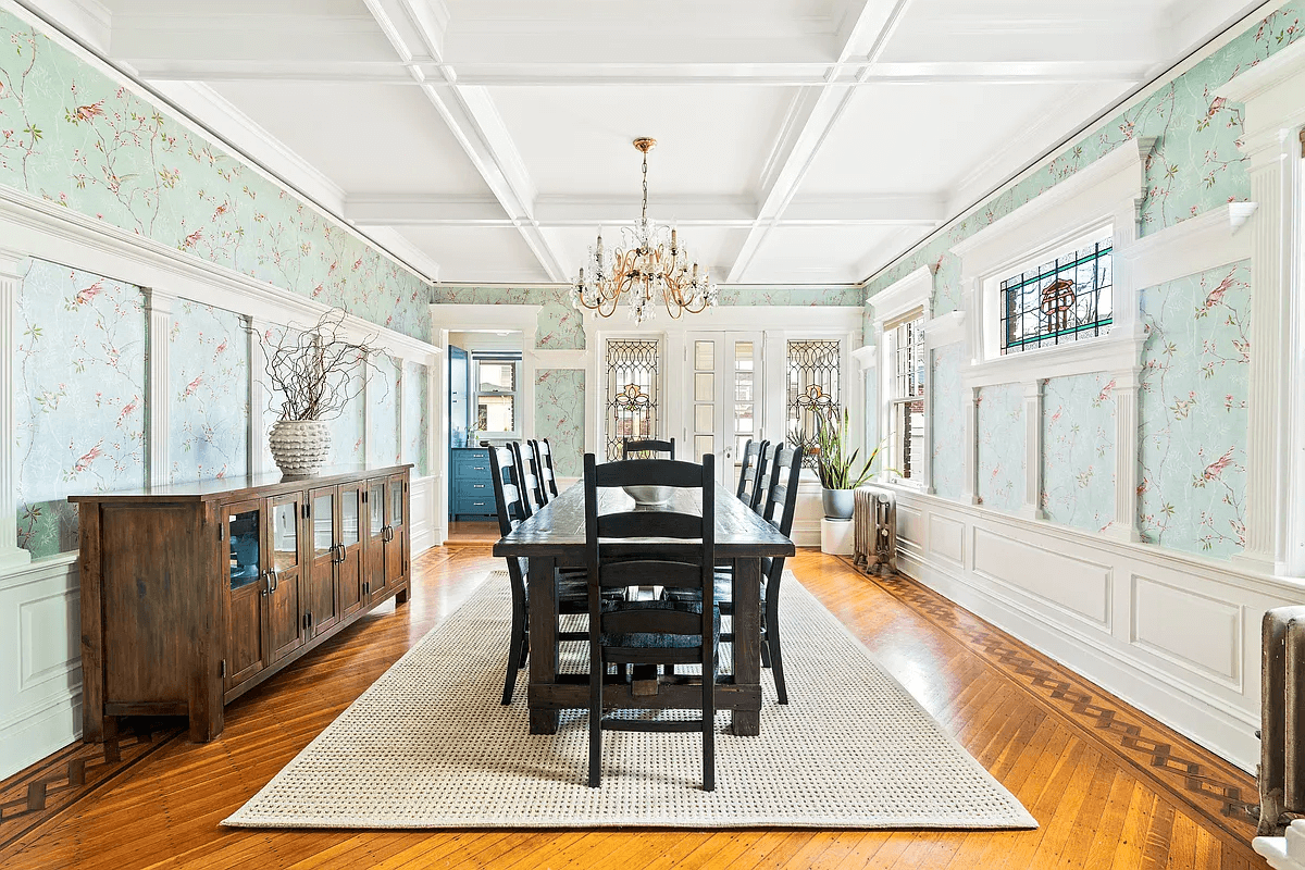 dining room with wallpaper and wainscoting