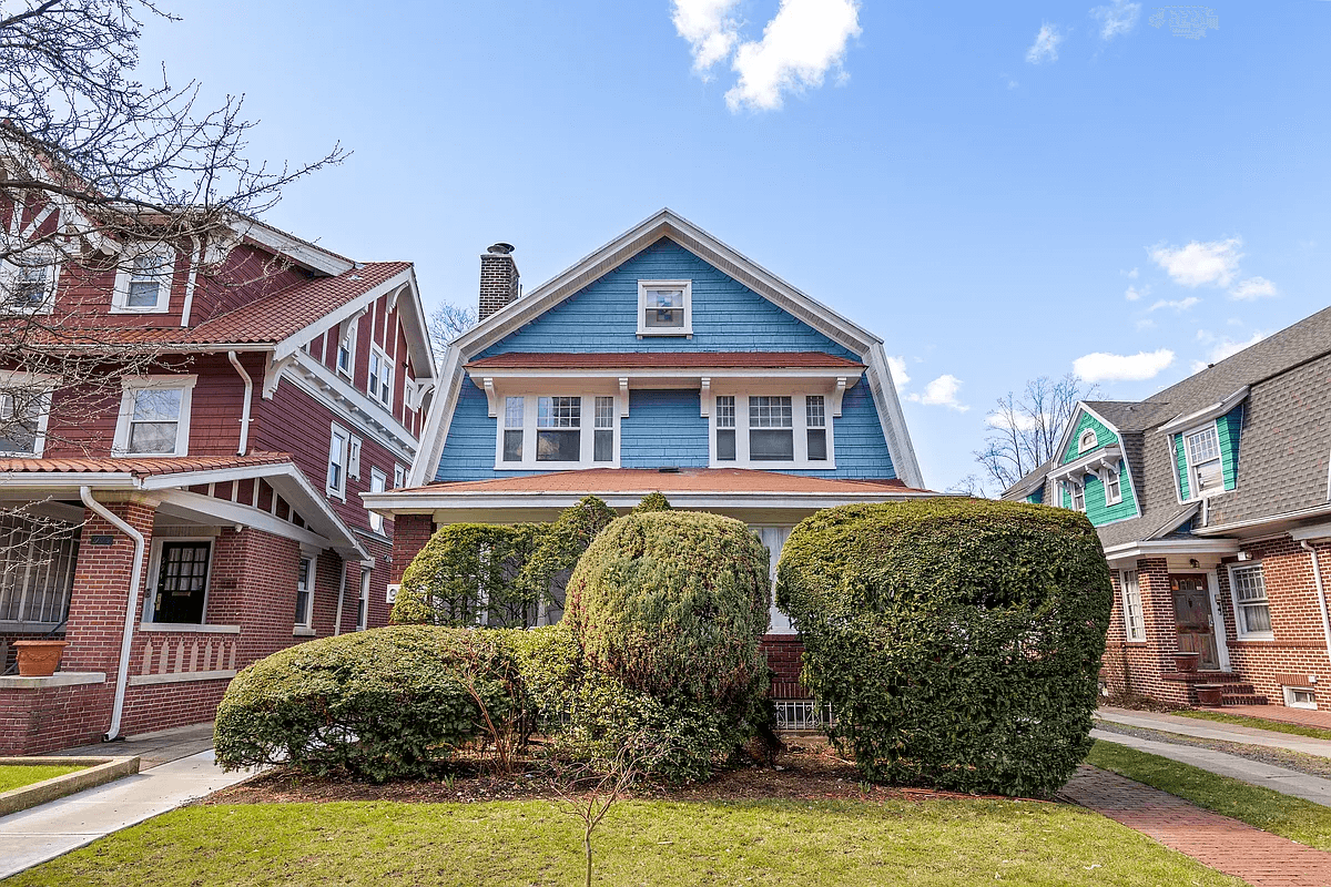 brookly house for sale exterior of the house with blue shingle and shrubs in front of first floor