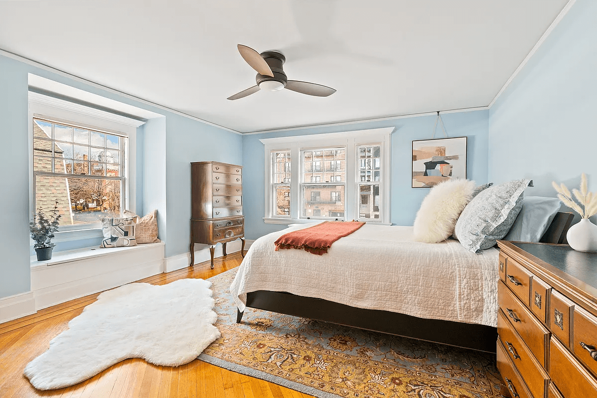 bedroom with window seat and wood floors